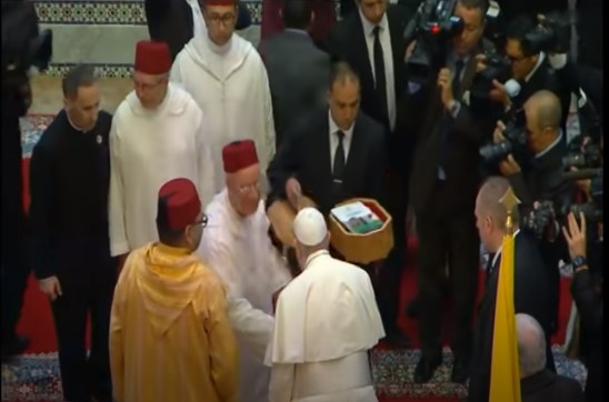 A book is presented in a basket to the pope and the king of Morocco